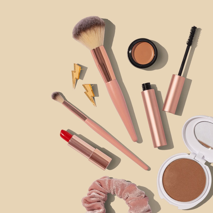 Flat lay of assorted makeup products and brushes on a neutral surface